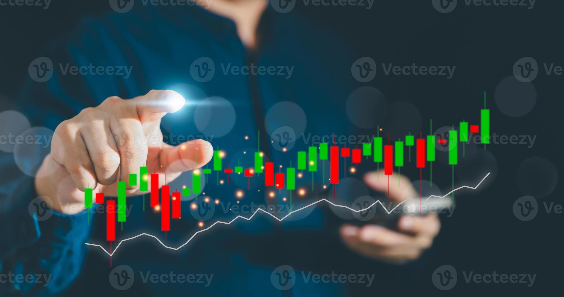 Businessman using mobile while finger touch stock market diagrams, hologram with lines and candlesticks on virtual screen, buy and sell. Concept of online trading on smartphone application photo