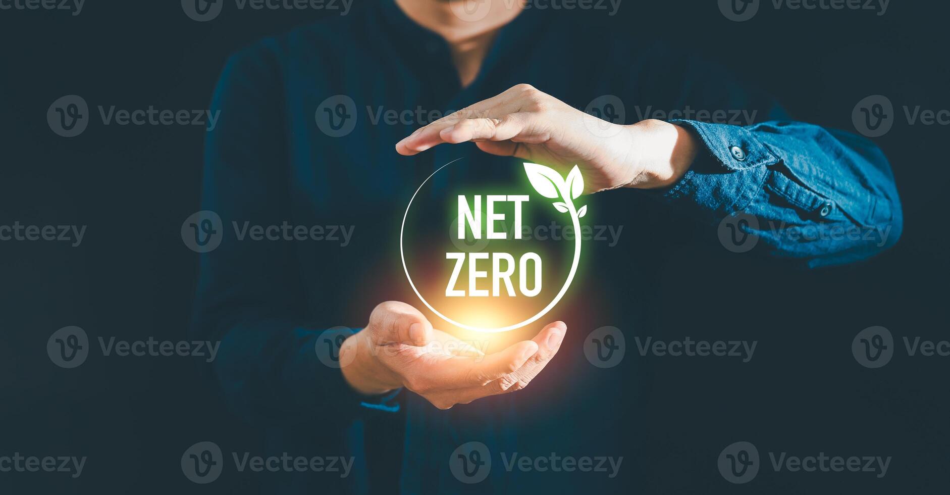 Businessman holding net zero icon with globe outline background for Net zero and carbon neutral concept. Net zero greenhouse gas emissions target. Climate neutral long term strategy. photo