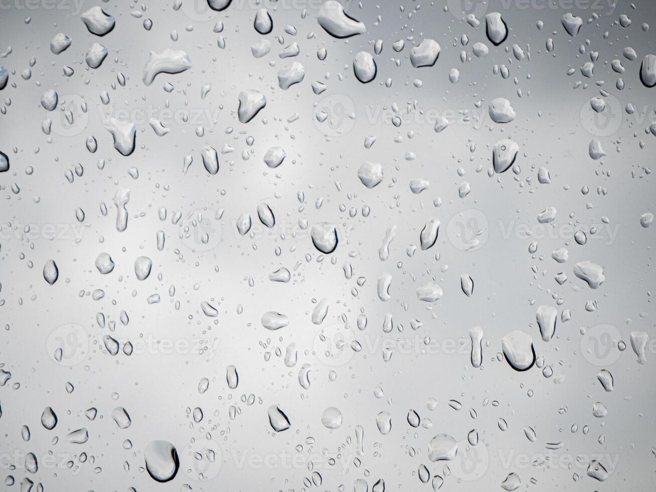 Rain and dew drop on the car glass window during raining. photo