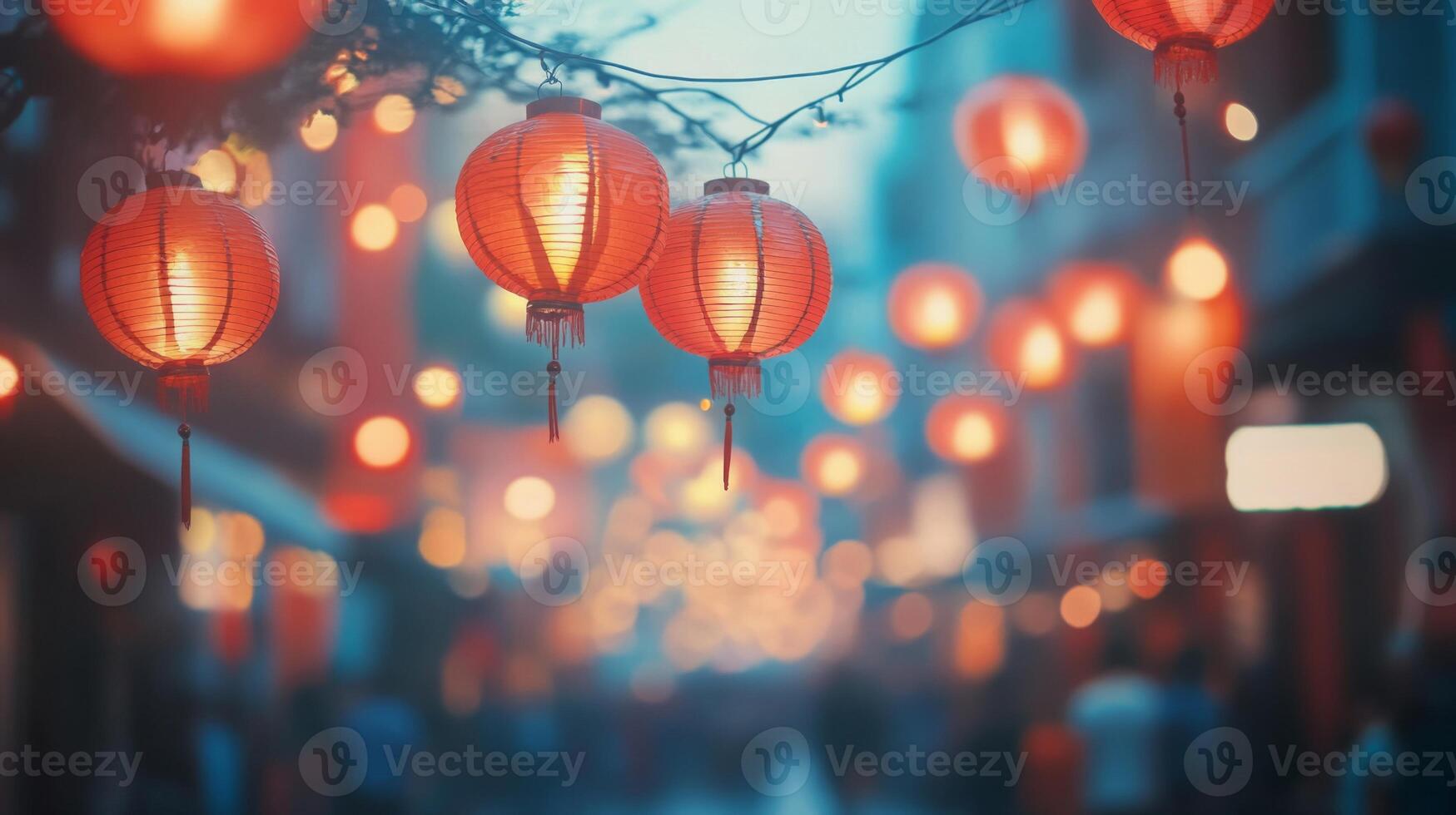Festive red lanterns hanging above a city street, softly glowing in the evening light, with a blurred crowd in the background celebrating a festival. photo