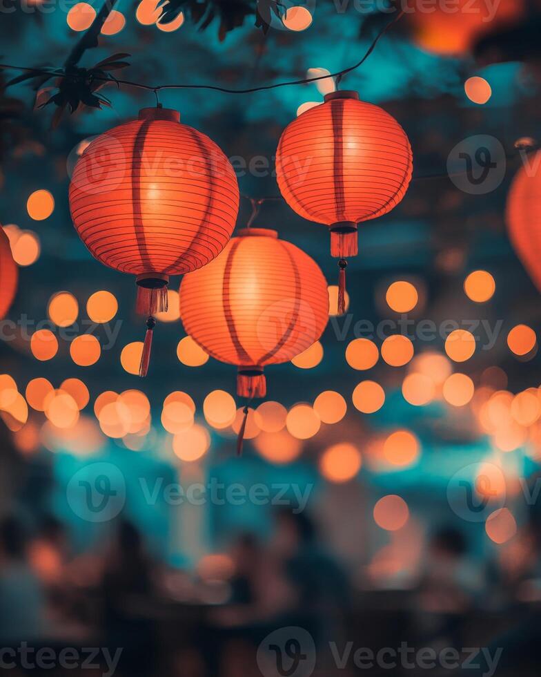 Vibrant red lanterns swaying gently, surrounded by blurry lights and a festive crowd in the background, glowing softly under warm lighting photo