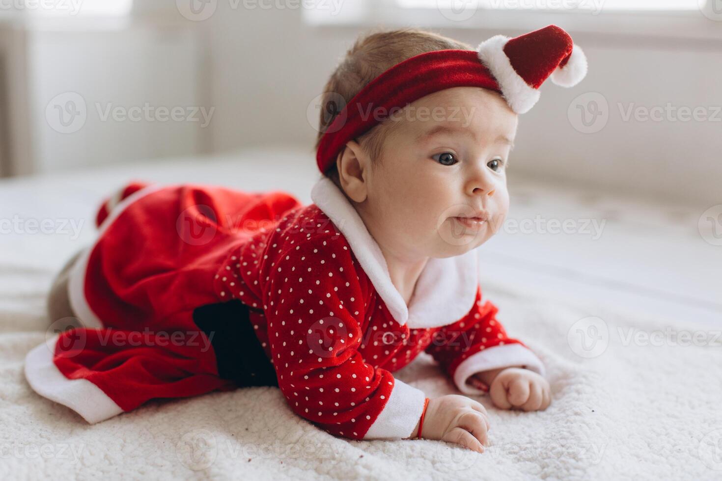 Portrait of a funny little baby girl in Christmas clothes photo