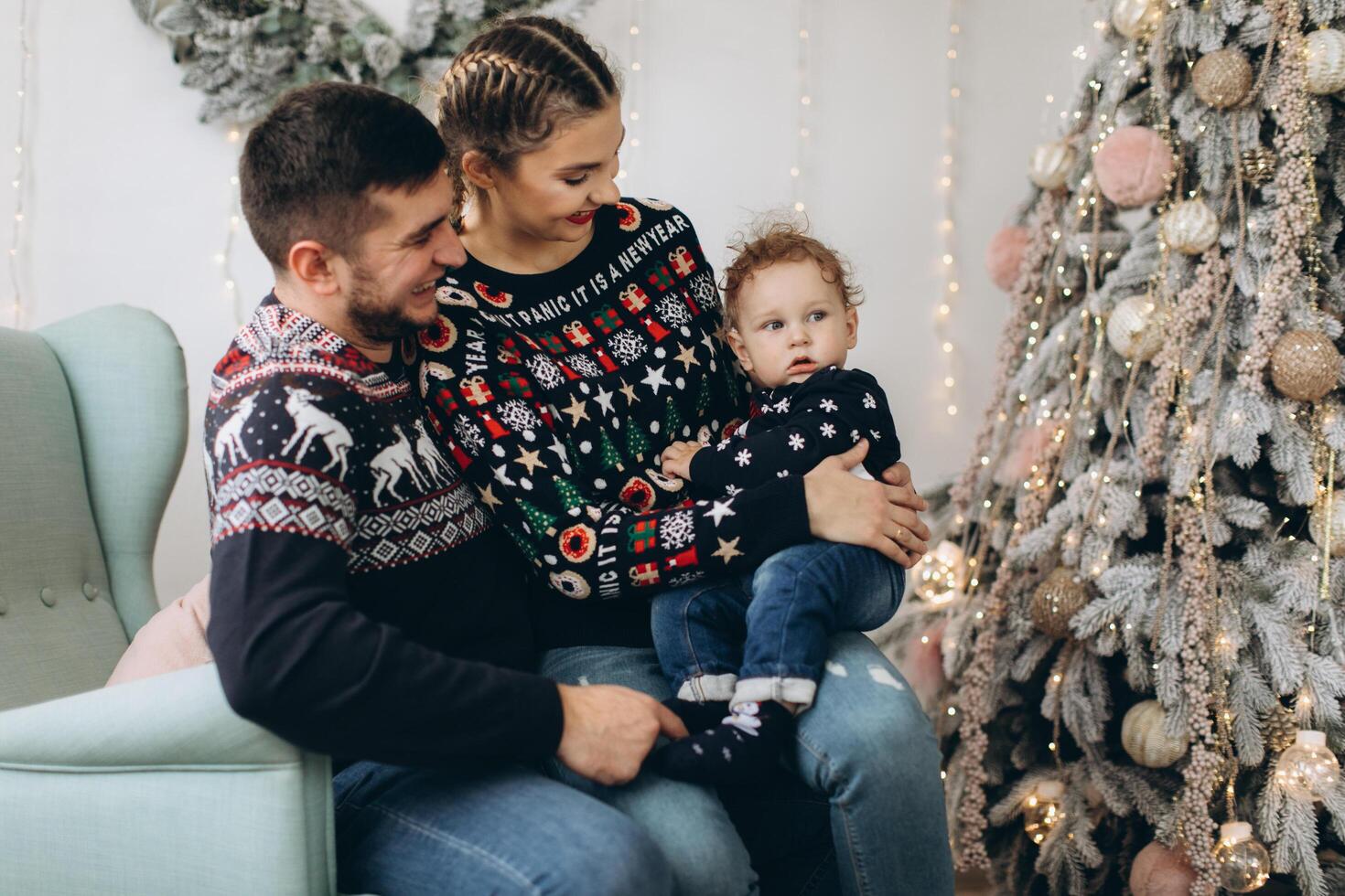 Portrait of happy family of father mother and little curly son celebrating Christmas together at home. photo
