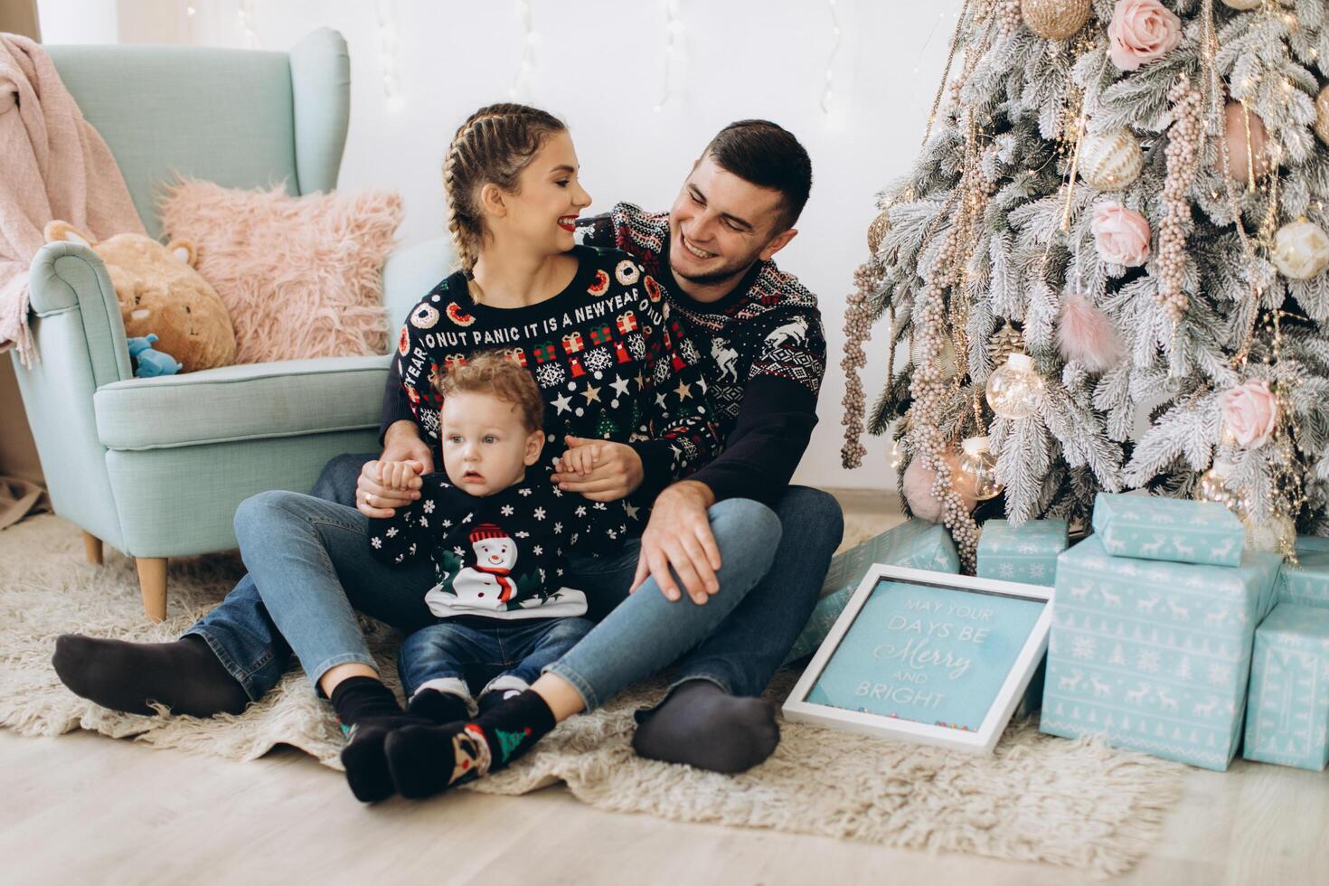 Portrait of happy family of father mother and little curly son celebrating Christmas together at home. photo