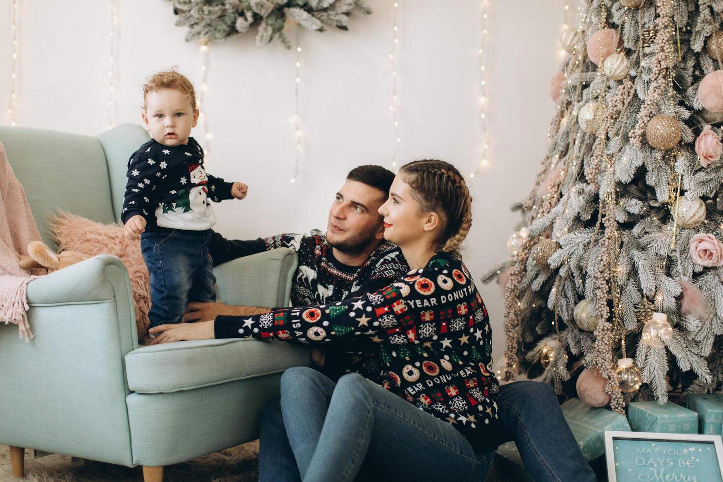 Portrait of happy family of father mother and little curly son celebrating Christmas together at home. photo