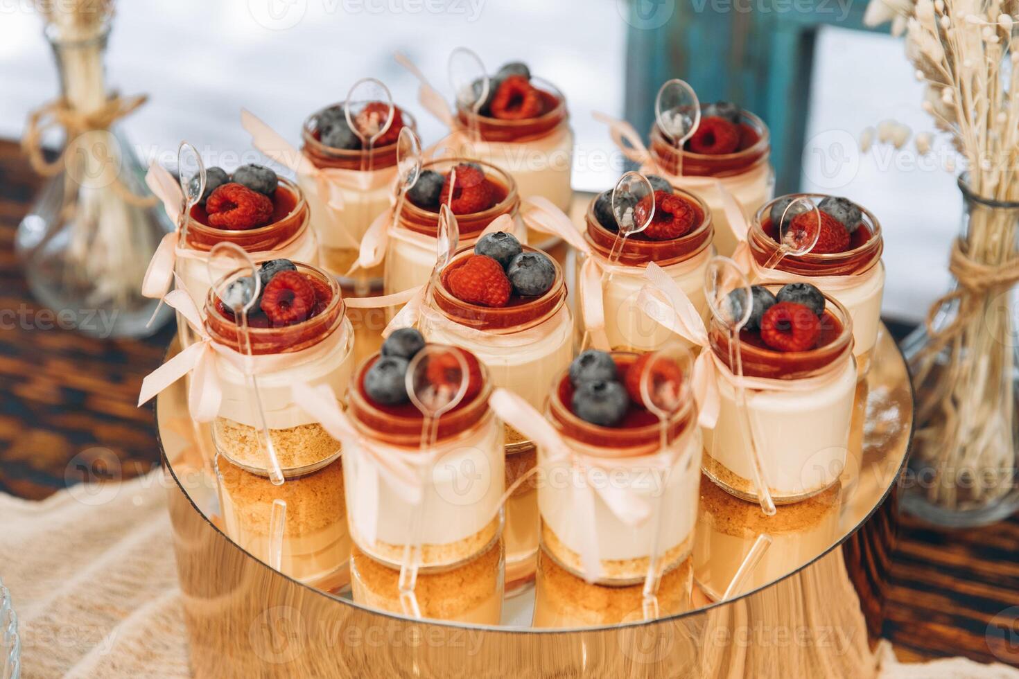 A delicious sweet buffet for a wedding. Tiramisu, cupcakes, sweets decorated with raspberries and blueberries photo