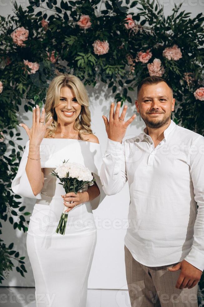 Joyful Couple Celebrating Their Engagement with Smiles and Rings in a Romantic Setting photo