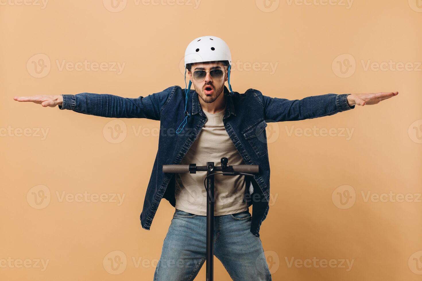 Stylish modern man in a helmet on an electronic scooter, photo in the studio
