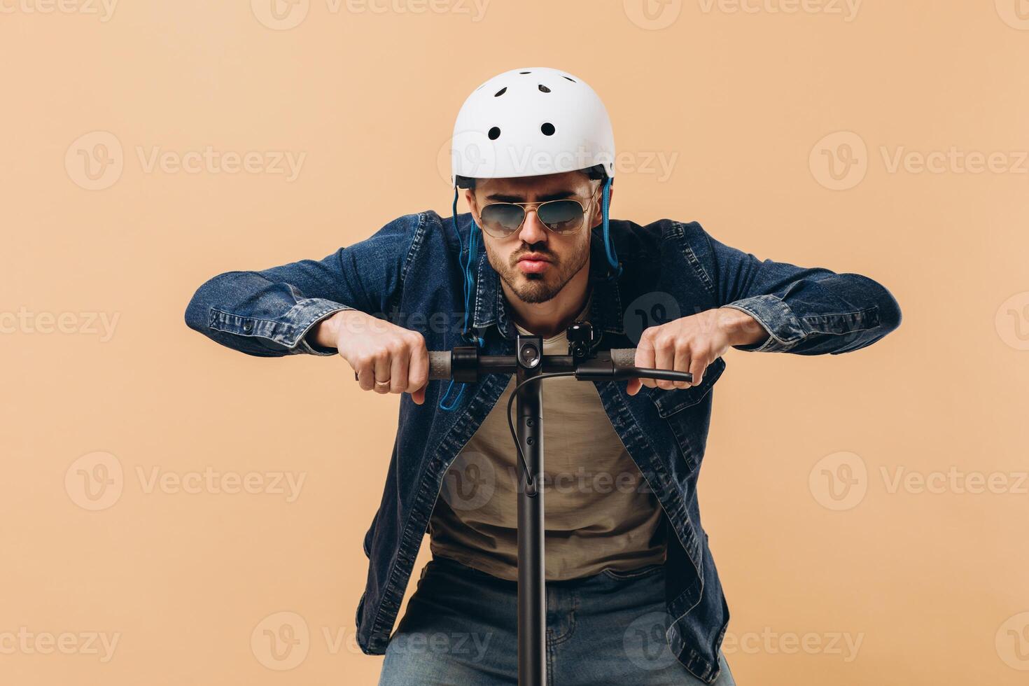 Stylish modern man in a helmet on an electronic scooter, photo in the studio