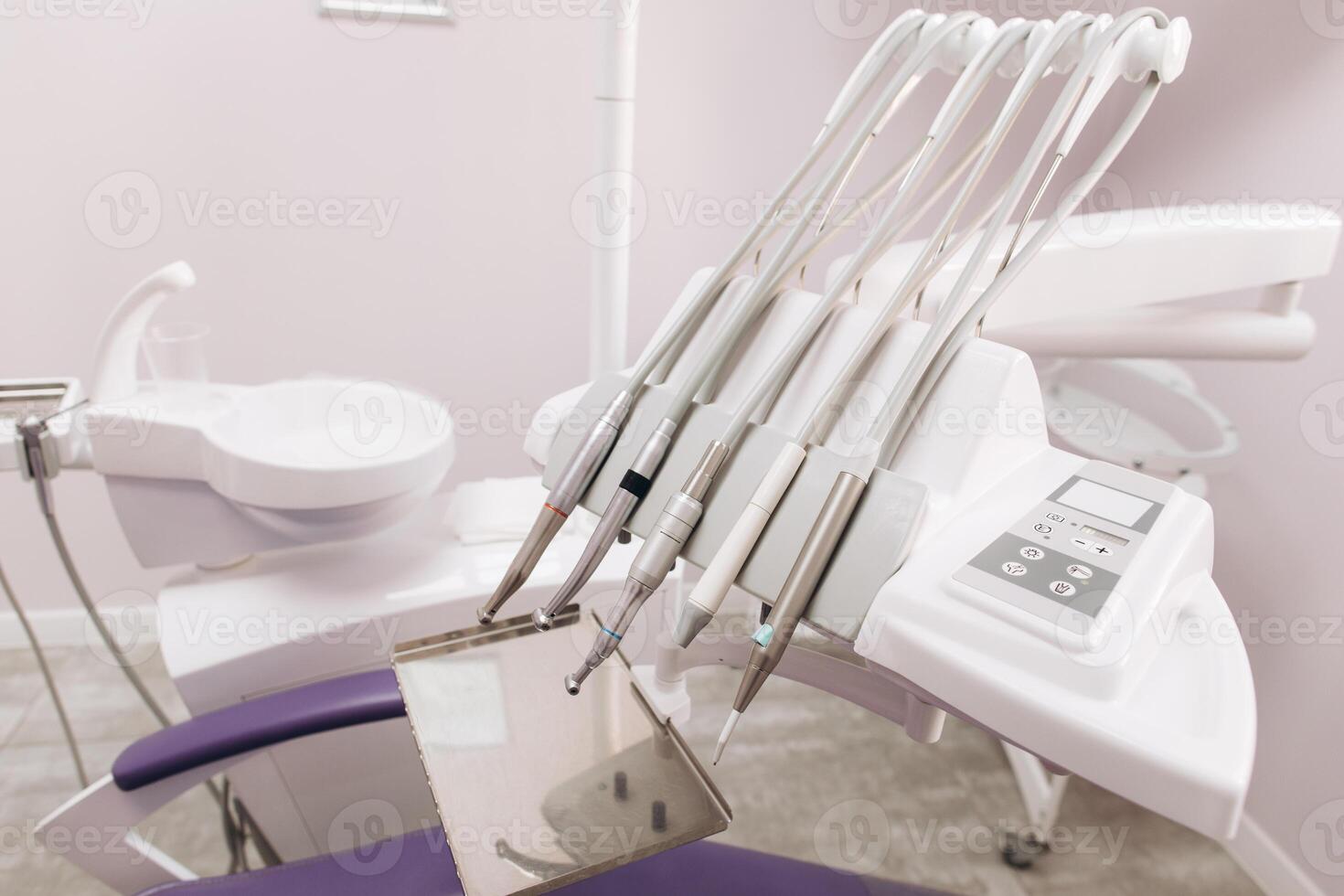 Modern dental practice. Dental chair and other accessories used by dentists in violet, copper light photo