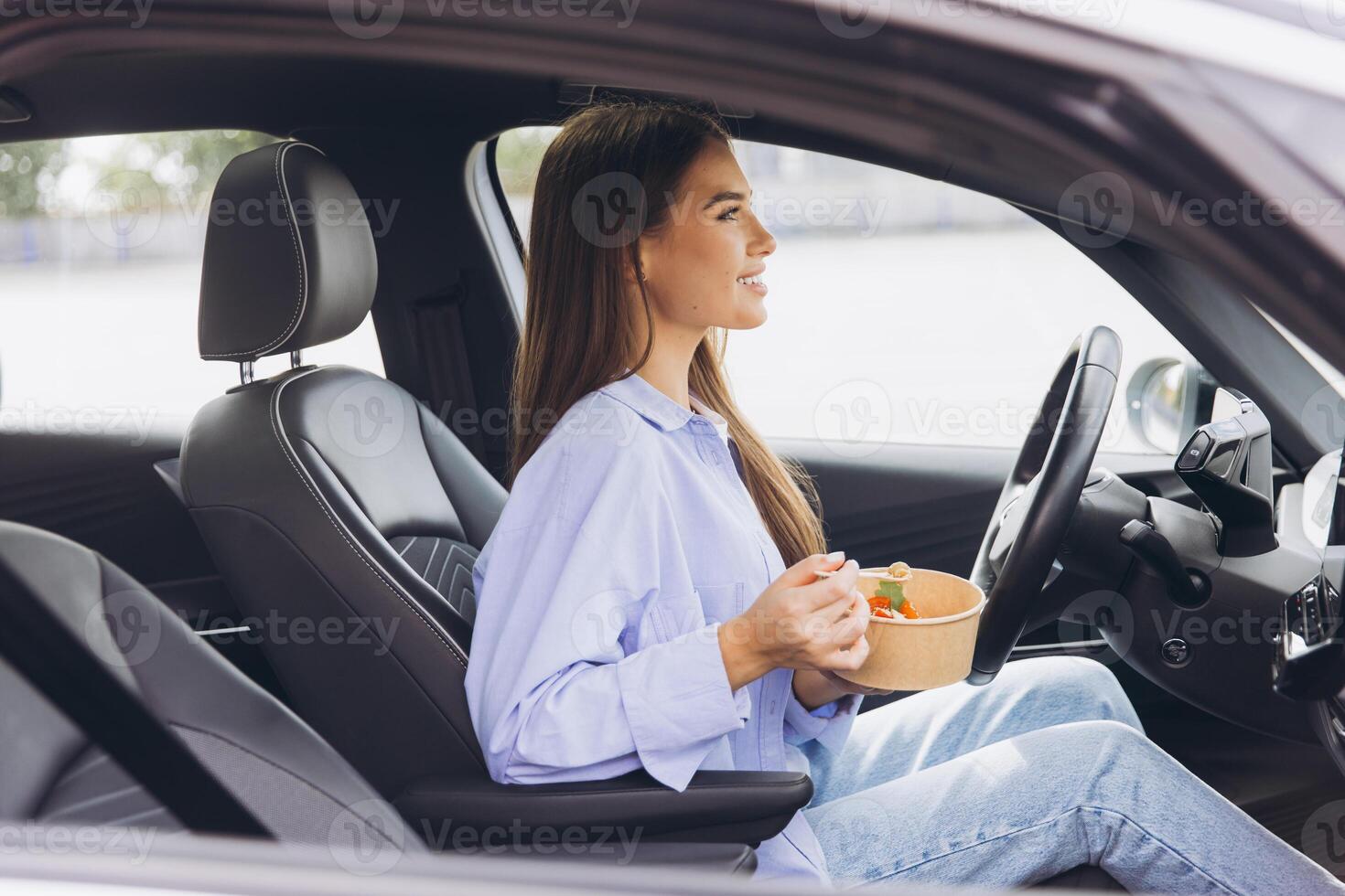 Woman Enjoying a Healthy Meal Inside Her Car While Parked, Emphasizing Convenience and Modern Lifestyle Choices for Busy Individuals On the Go photo