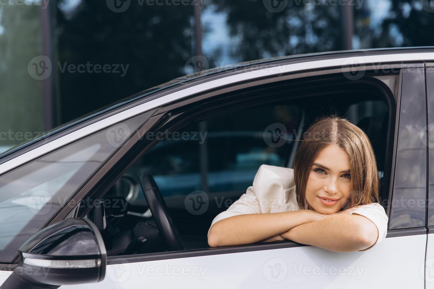 Young Woman Relaxing in Car Window on a Sunny Day photo