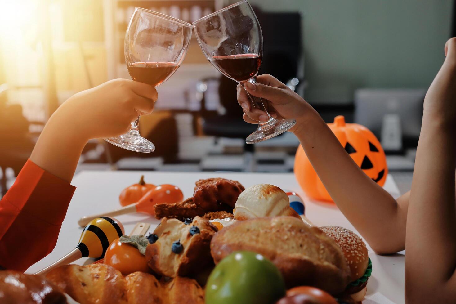 friendship, holiday and people concept - group of happy smiling friends in halloween costumes of vampire, devil, witch and cheetah at home party photo