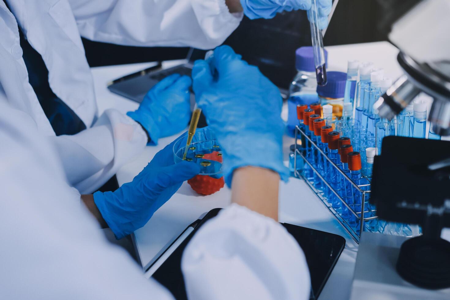 Scientist using microscope in laboratory. Close-up of a researcher's hands adjusting a modern microscope in a lab setting. Science concept photo