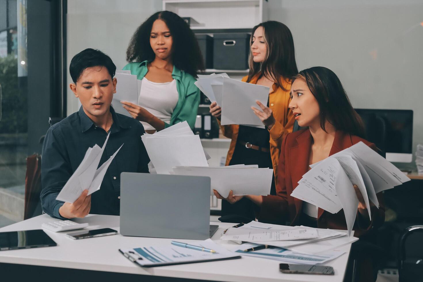 Stress, business people and employee frustrated with multitasking, pressure or overworked by team in chaos with paperwork. Anxiety, headache and worker overwhelmed by group and burnout in crisis photo