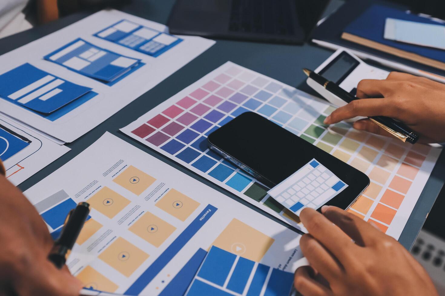 The designer team is designing the uxui system to make the uxui system work well on new phones and support system updates. Website development concept UI UX front end designer photo
