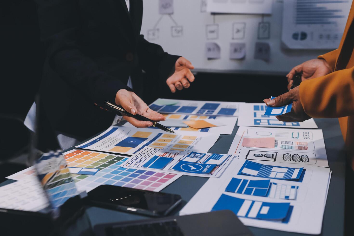 The designer team is designing the uxui system to make the uxui system work well on new phones and support system updates. Website development concept UI UX front end designer photo