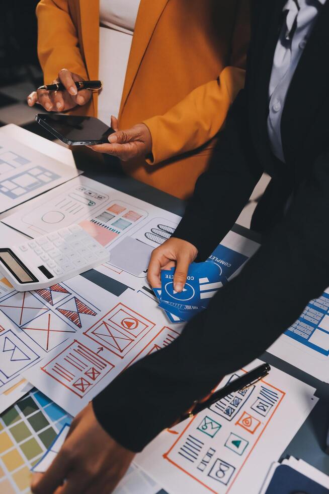 The designer team is designing the uxui system to make the uxui system work well on new phones and support system updates. Website development concept UI UX front end designer photo