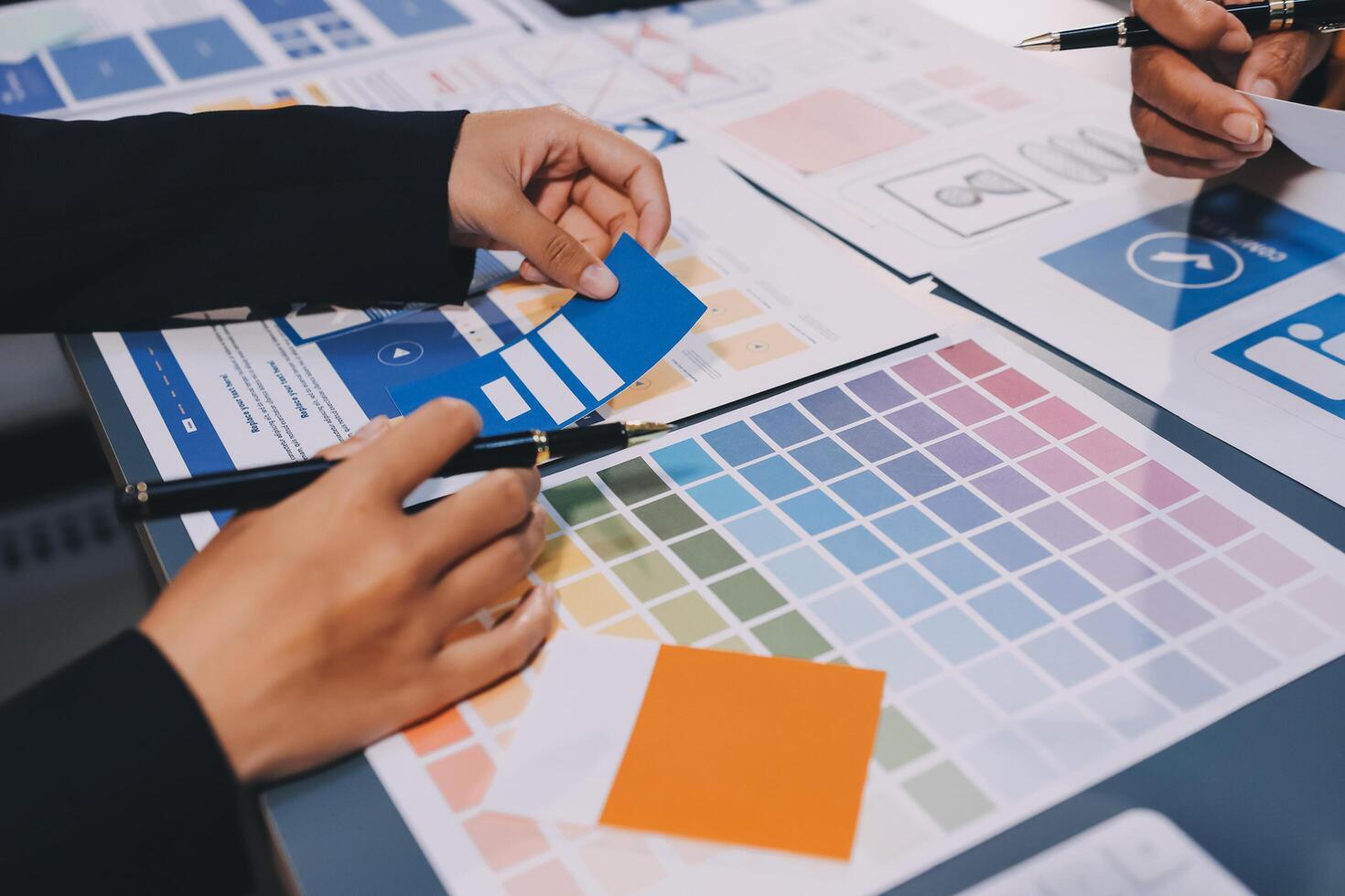 The designer team is designing the uxui system to make the uxui system work well on new phones and support system updates. Website development concept UI UX front end designer photo