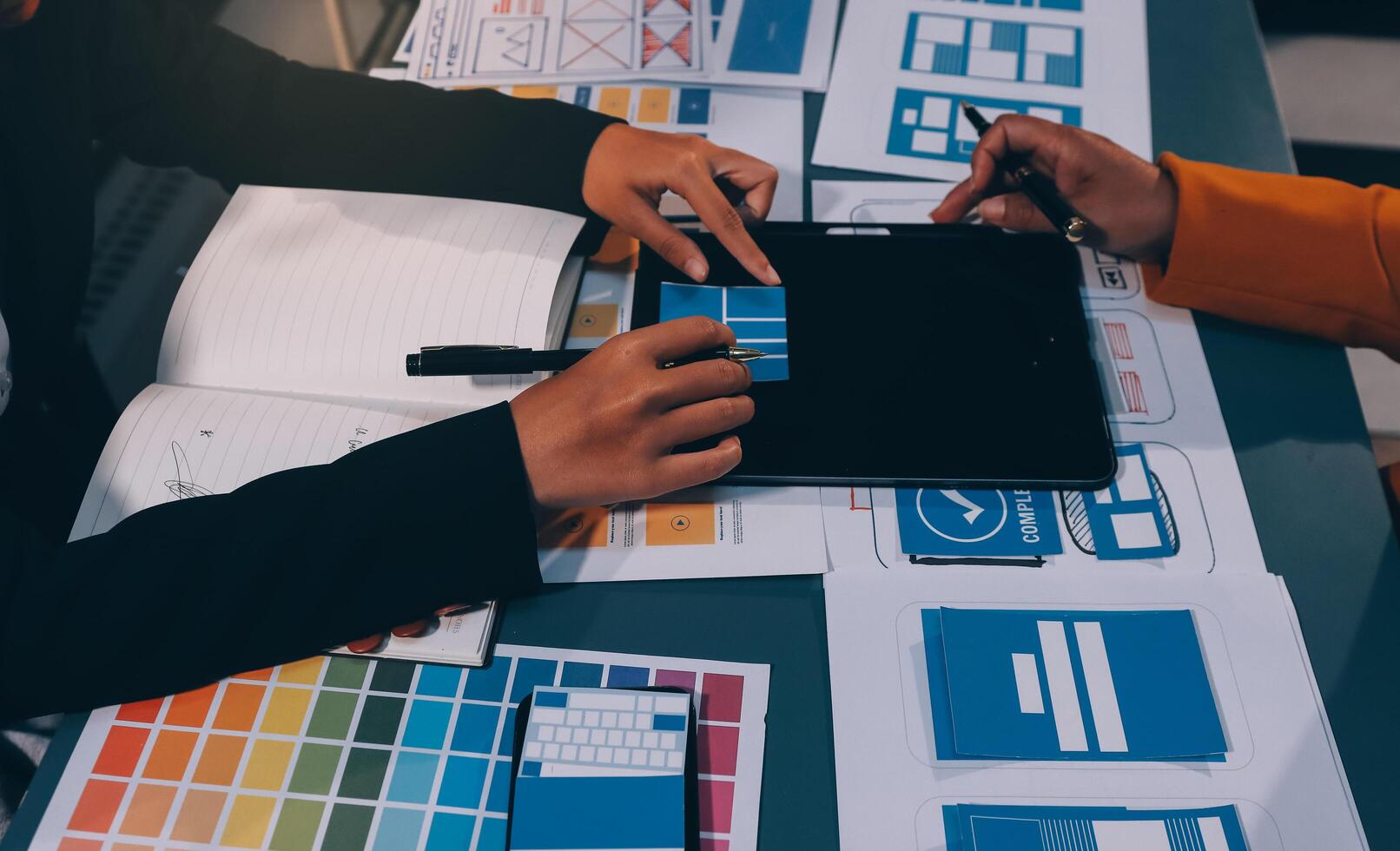 The designer team is designing the uxui system to make the uxui system work well on new phones and support system updates. Website development concept UI UX front end designer photo