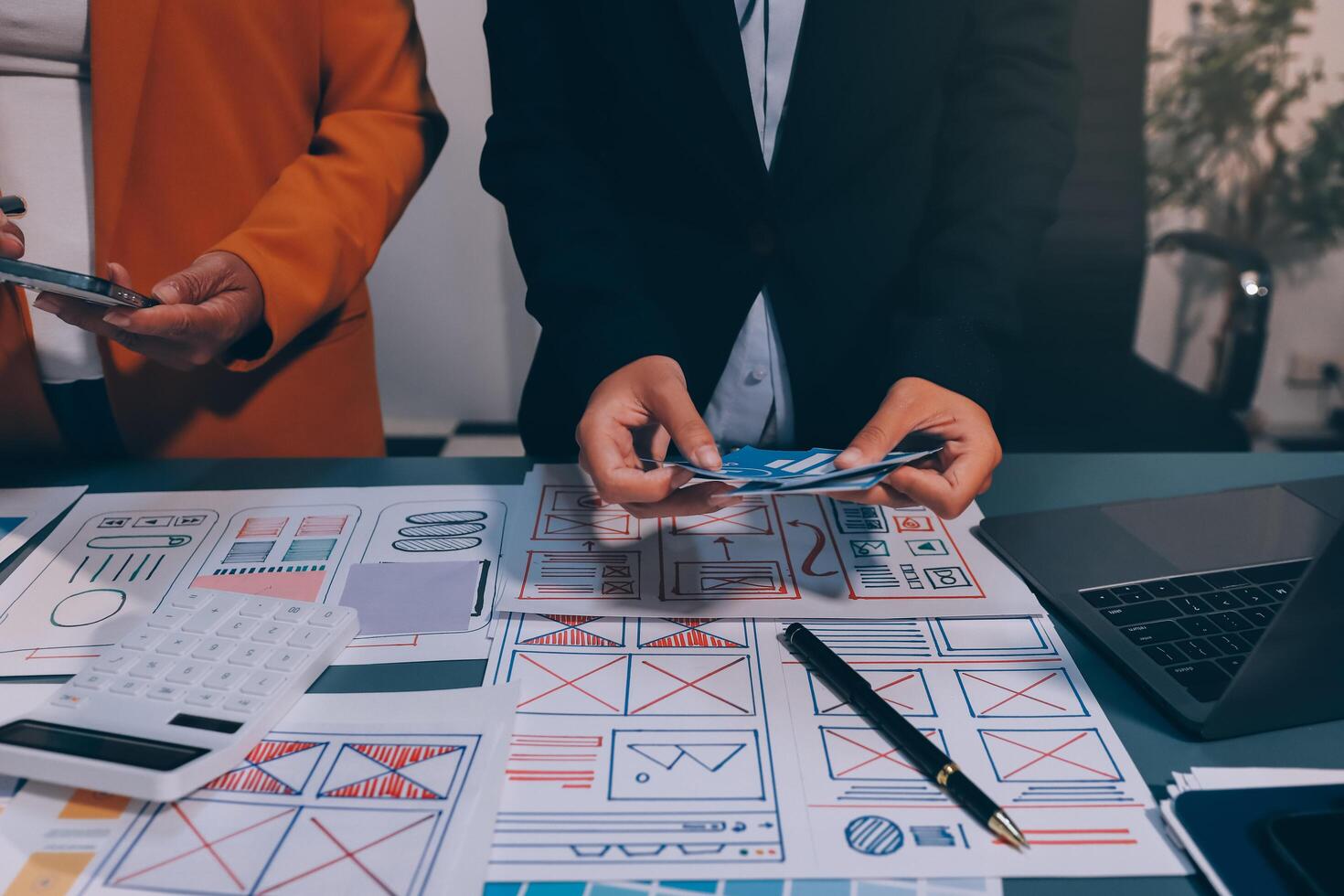 The designer team is designing the uxui system to make the uxui system work well on new phones and support system updates. Website development concept UI UX front end designer photo