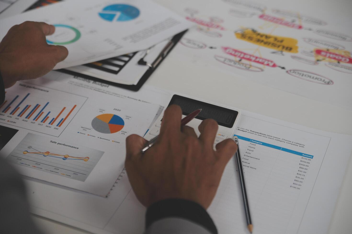 Close up of Business team analyzing income charts and graphs with modern laptop computer. Business analysis and strategy concept. photo