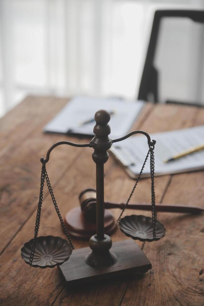 Judge gavel with Justice lawyers having team meeting at law firm background. Concepts of Law and Legal services. photo