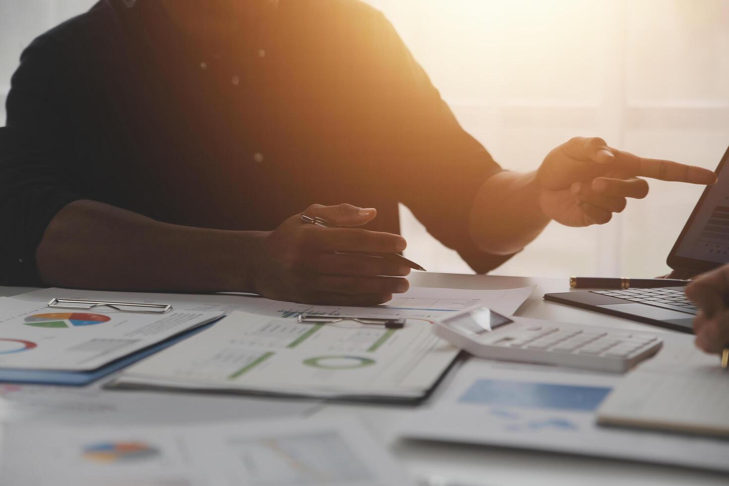 Close up of Business team analyzing income charts and graphs with modern laptop computer. Business analysis and strategy concept. photo