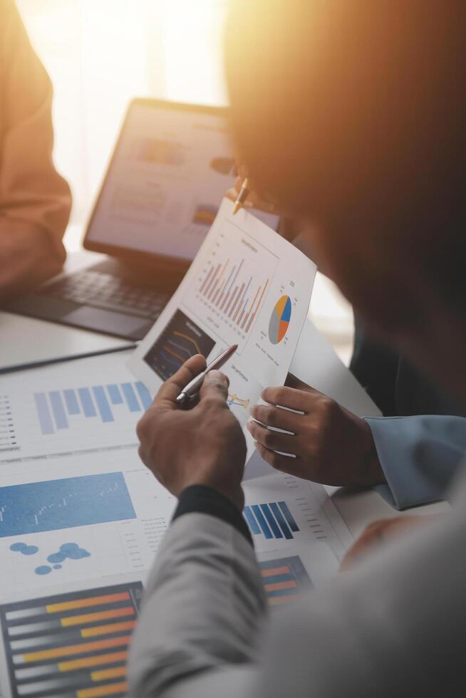 Close up of Business team analyzing income charts and graphs with modern laptop computer. Business analysis and strategy concept. photo