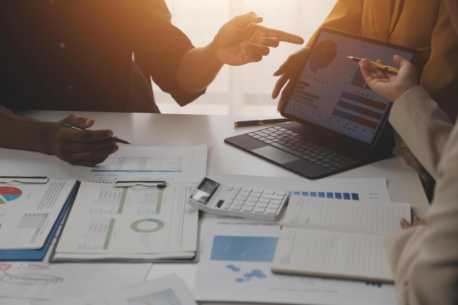 Close up of Business team analyzing income charts and graphs with modern laptop computer. Business analysis and strategy concept. photo