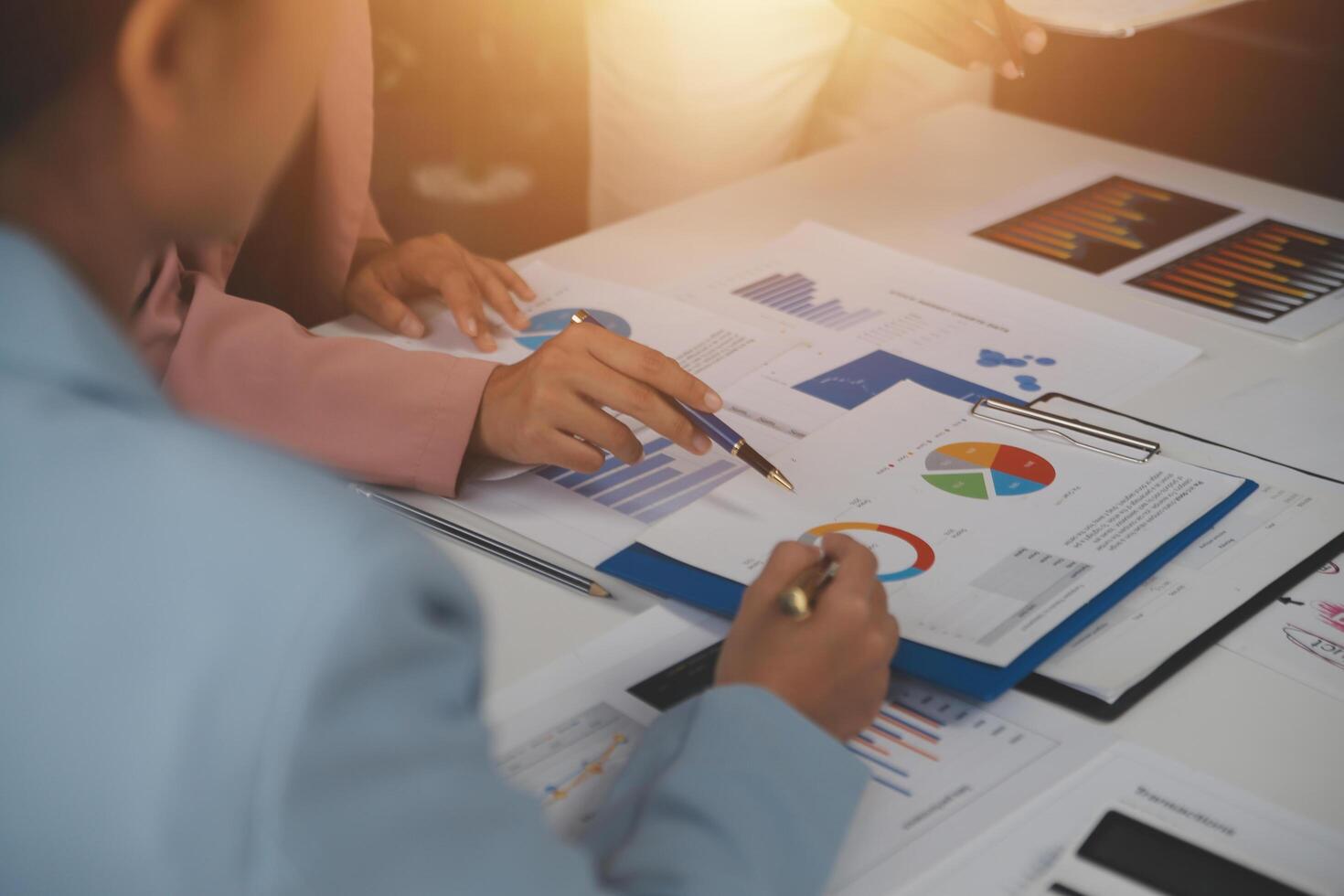 Close up of Business team analyzing income charts and graphs with modern laptop computer. Business analysis and strategy concept. photo