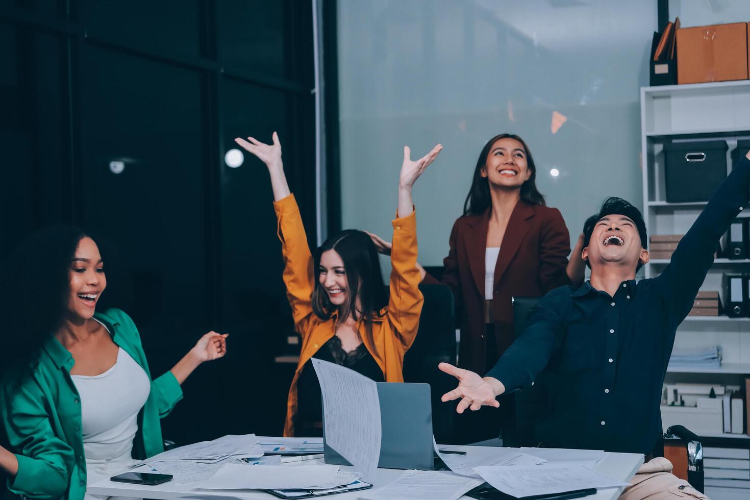 Motivated funny diverse business team people dancing celebrating success at corporate party on friday, happy friendly multiracial coworkers group having fun together enjoy victory dance in office photo
