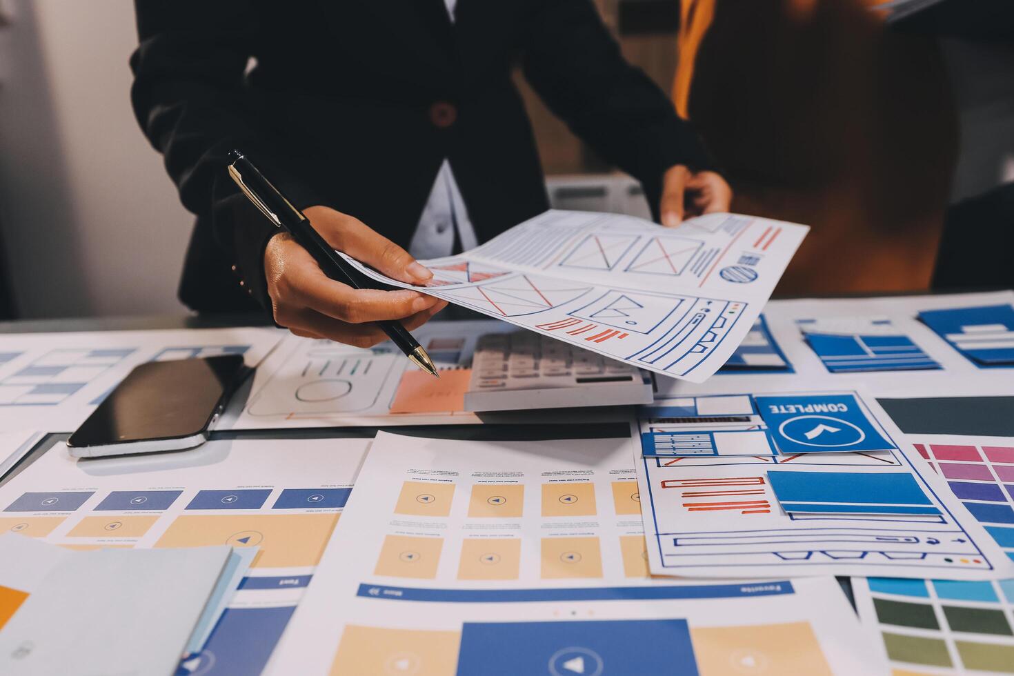 The designer team is designing the uxui system to make the uxui system work well on new phones and support system updates. Website development concept UI UX front end designer photo