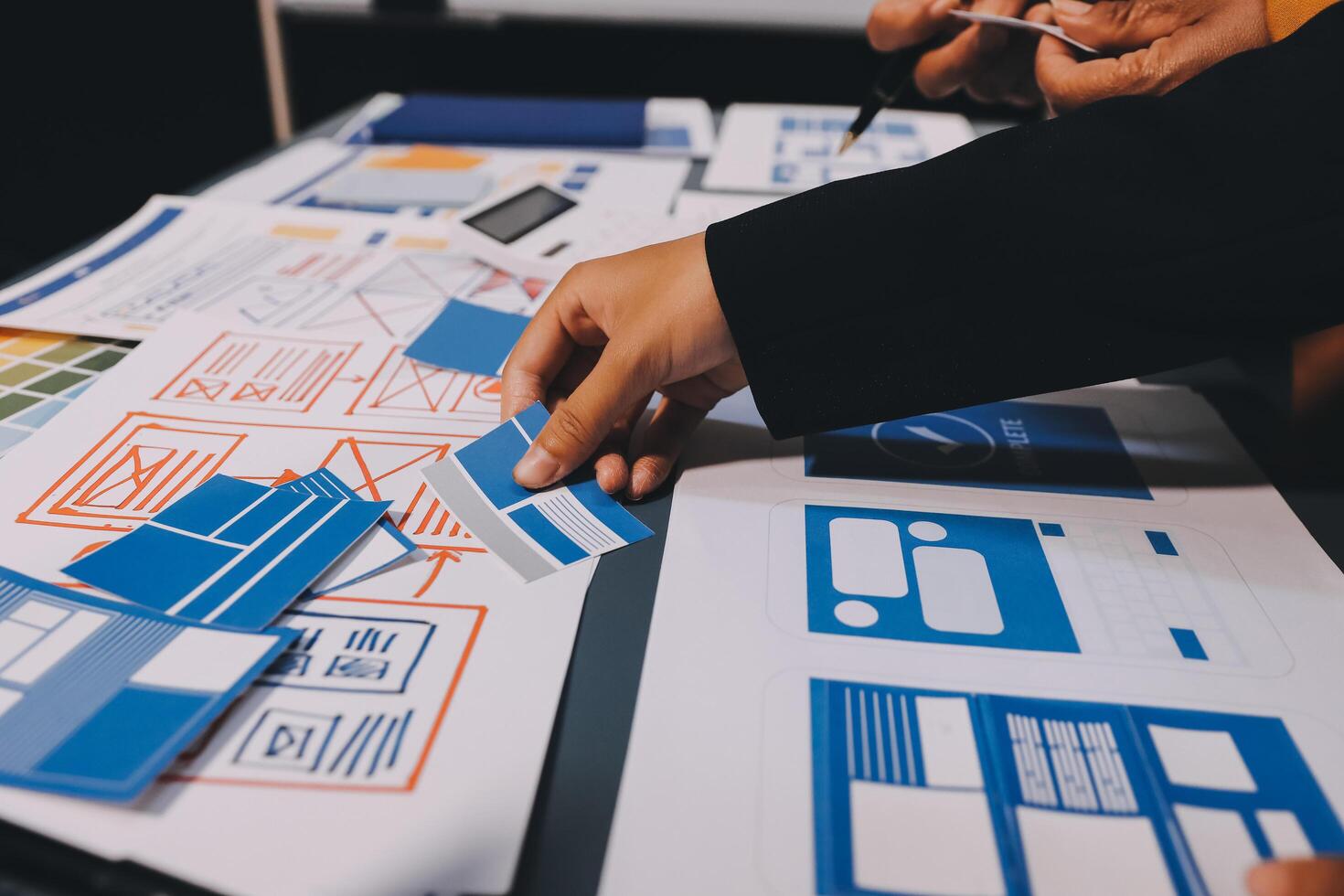 The designer team is designing the uxui system to make the uxui system work well on new phones and support system updates. Website development concept UI UX front end designer photo