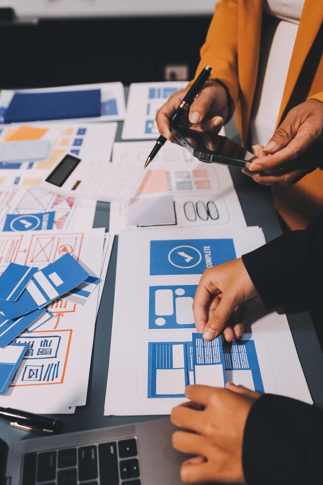 The designer team is designing the uxui system to make the uxui system work well on new phones and support system updates. Website development concept UI UX front end designer photo