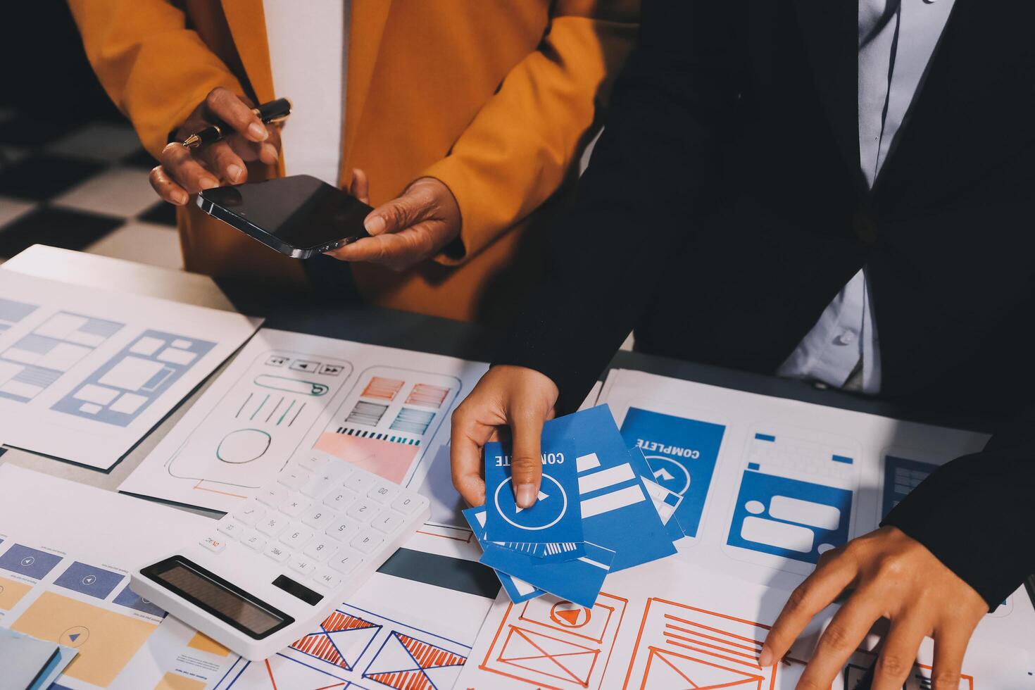 The designer team is designing the uxui system to make the uxui system work well on new phones and support system updates. Website development concept UI UX front end designer photo