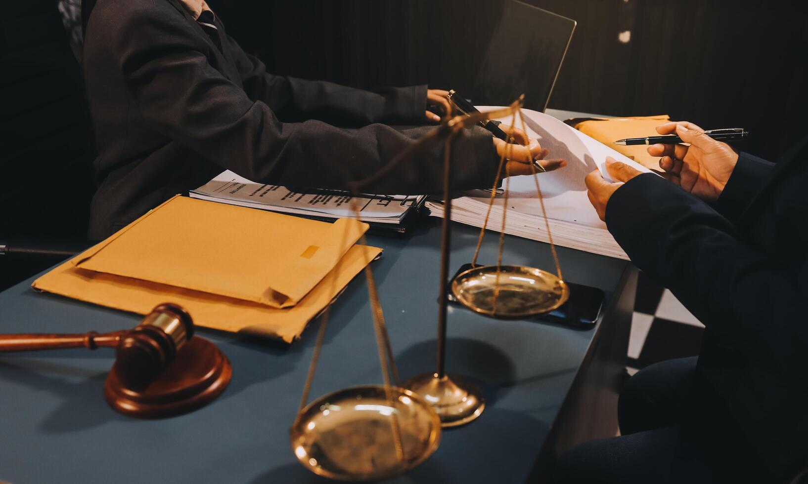 Judge gavel with Justice lawyers having team meeting at law firm background. Concepts of Law and Legal services. photo