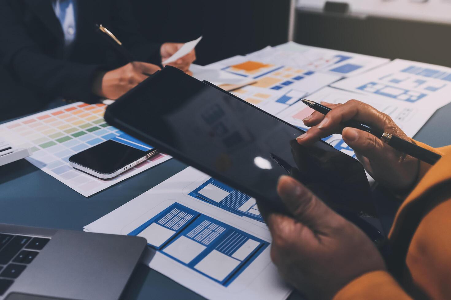 The designer team is designing the uxui system to make the uxui system work well on new phones and support system updates. Website development concept UI UX front end designer photo