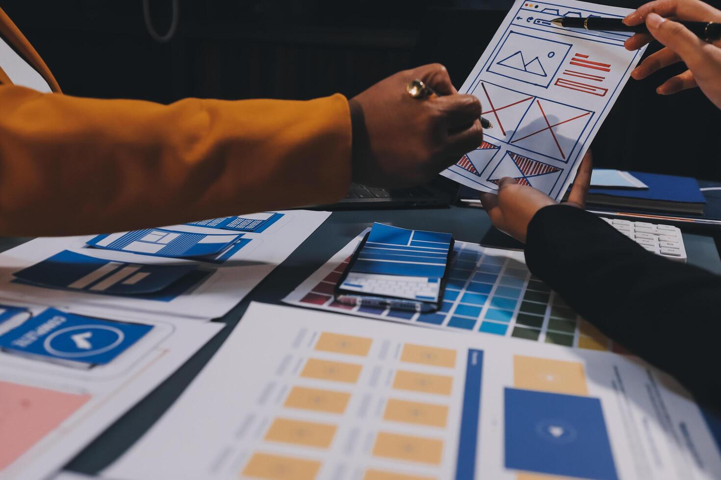 The designer team is designing the uxui system to make the uxui system work well on new phones and support system updates. Website development concept UI UX front end designer photo
