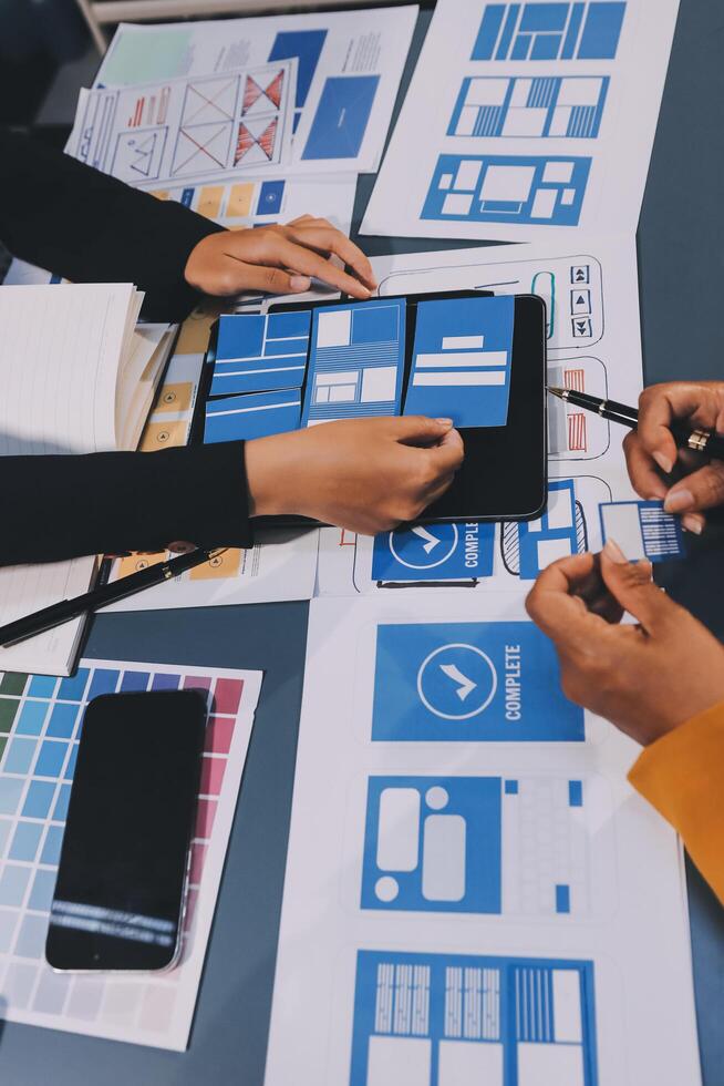The designer team is designing the uxui system to make the uxui system work well on new phones and support system updates. Website development concept UI UX front end designer photo