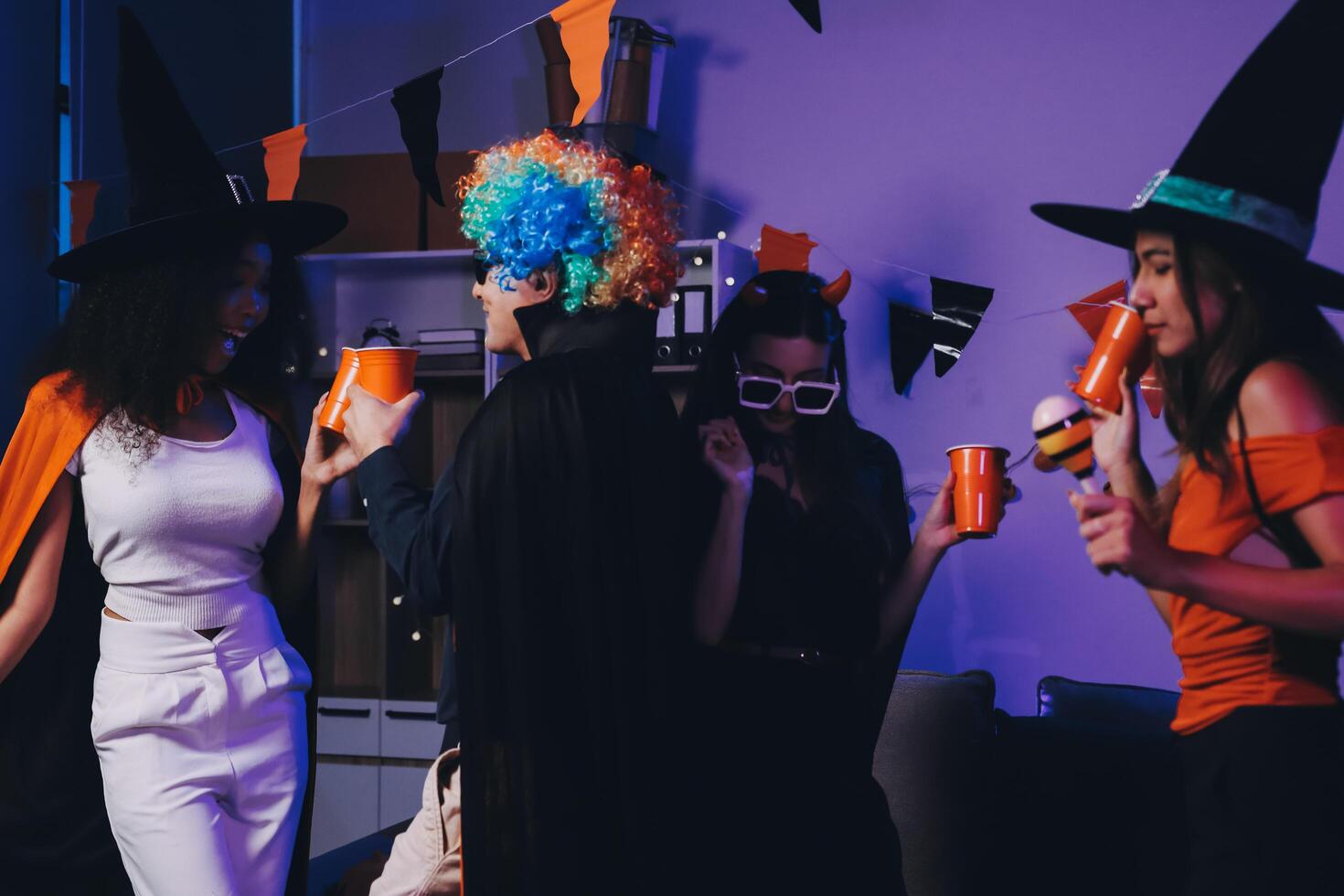 Joyful office Halloween party with coworkers in costumes, celebrating with drinks and laughter, fostering teamwork and festive spirit photo