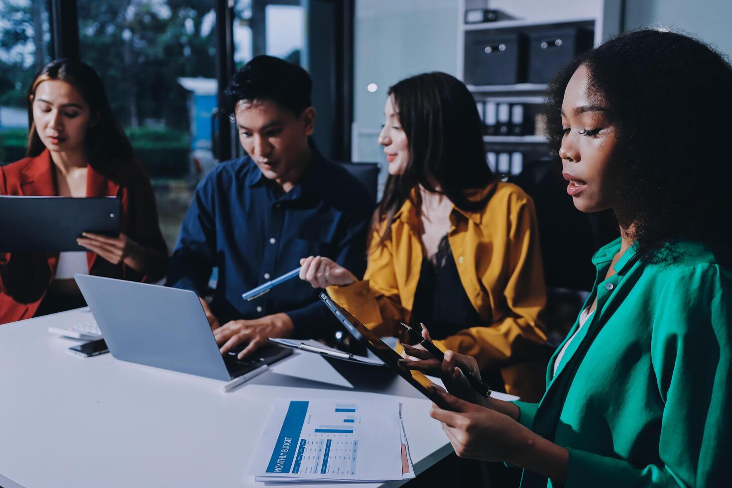 Young corporate employees sitting in office looking at laptop screen reading good news excited happy team diverse people celebrating victory win command success excellent result professional teamwork photo