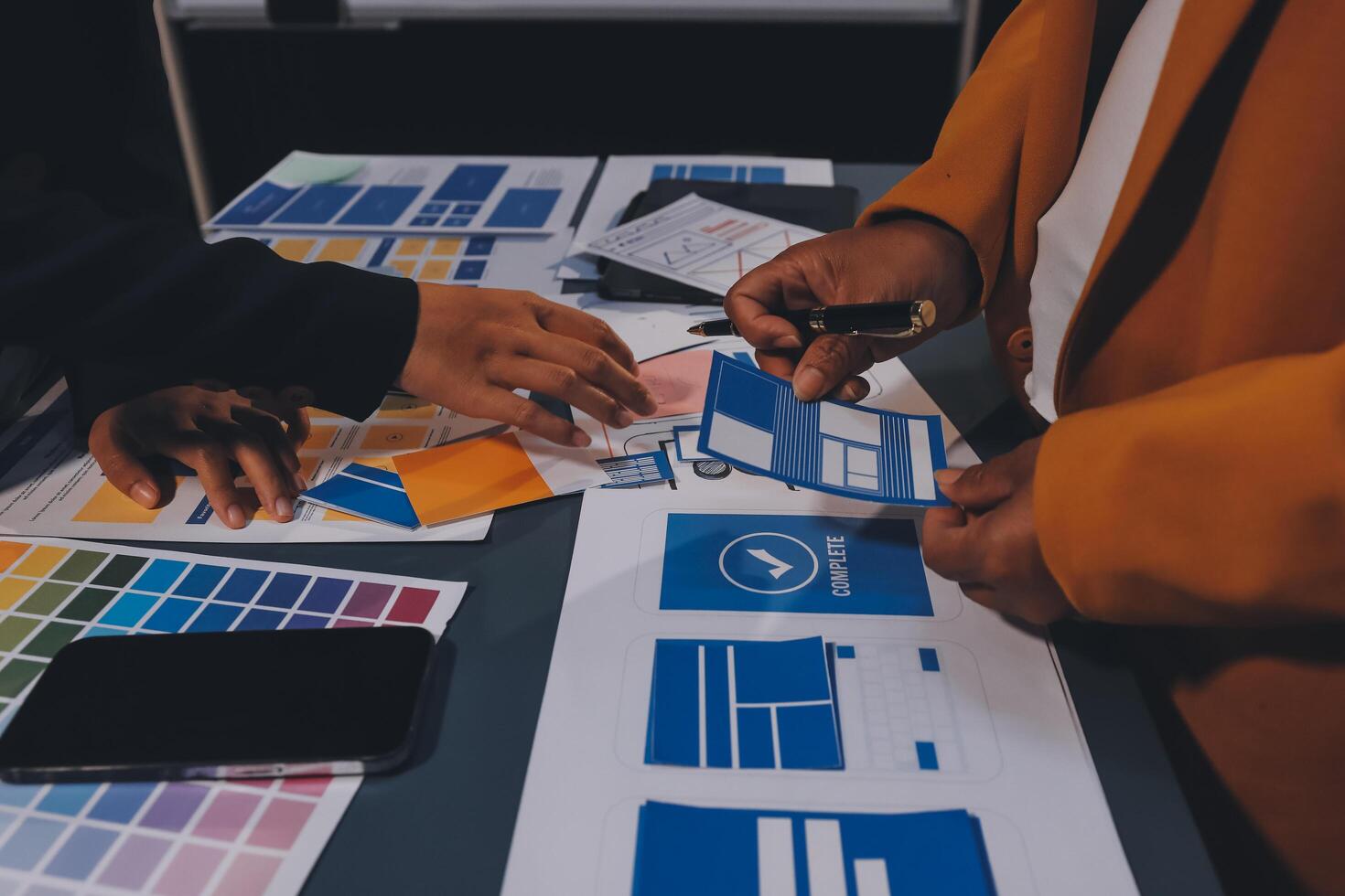 The designer team is designing the uxui system to make the uxui system work well on new phones and support system updates. Website development concept UI UX front end designer photo