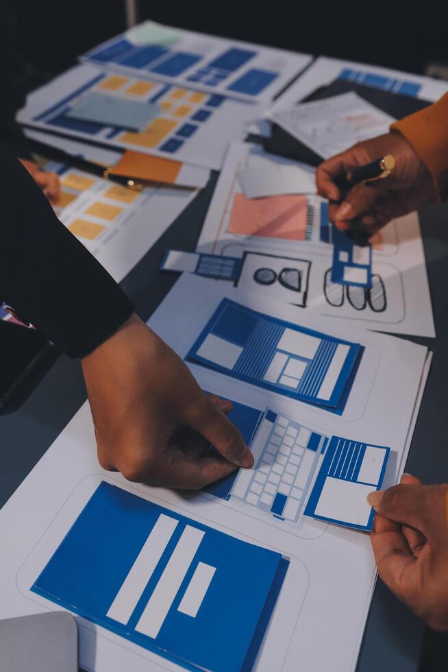 The designer team is designing the uxui system to make the uxui system work well on new phones and support system updates. Website development concept UI UX front end designer photo