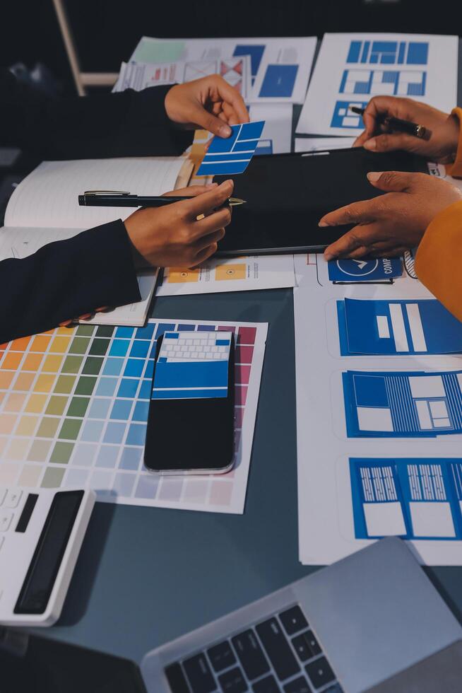 The designer team is designing the uxui system to make the uxui system work well on new phones and support system updates. Website development concept UI UX front end designer photo