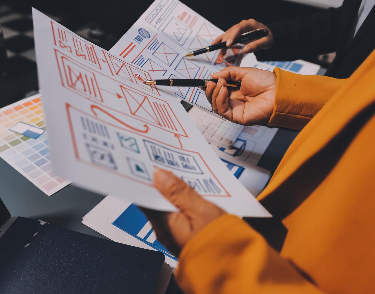 The designer team is designing the uxui system to make the uxui system work well on new phones and support system updates. Website development concept UI UX front end designer photo