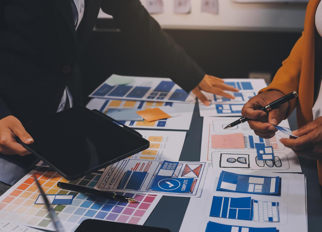 The designer team is designing the uxui system to make the uxui system work well on new phones and support system updates. Website development concept UI UX front end designer photo