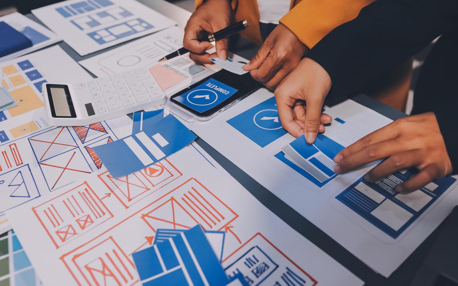 The designer team is designing the uxui system to make the uxui system work well on new phones and support system updates. Website development concept UI UX front end designer photo