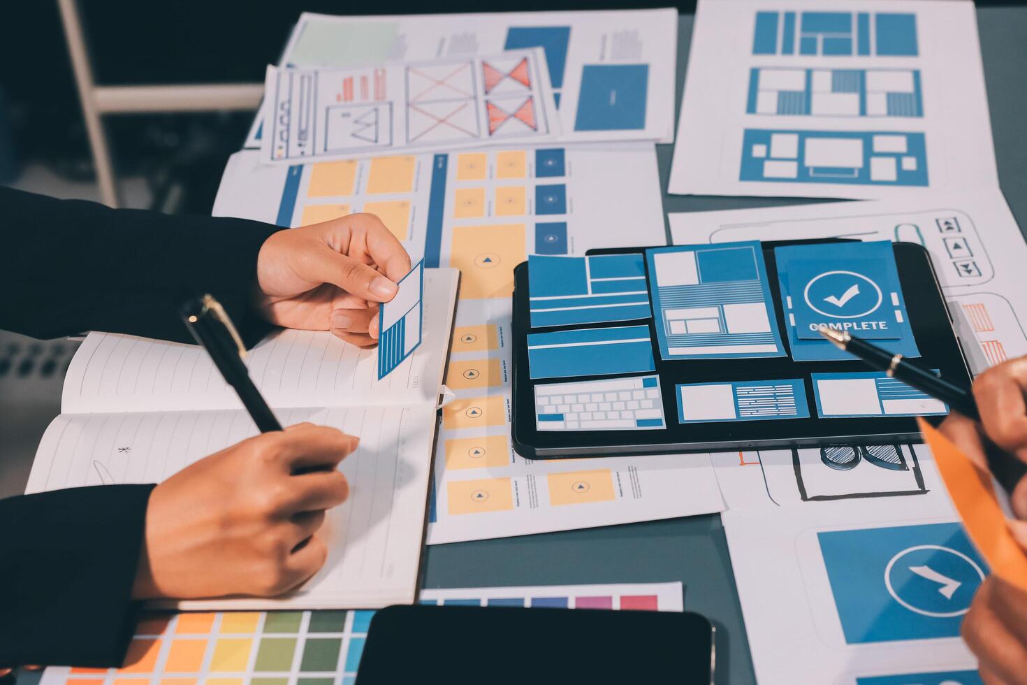The designer team is designing the uxui system to make the uxui system work well on new phones and support system updates. Website development concept UI UX front end designer photo