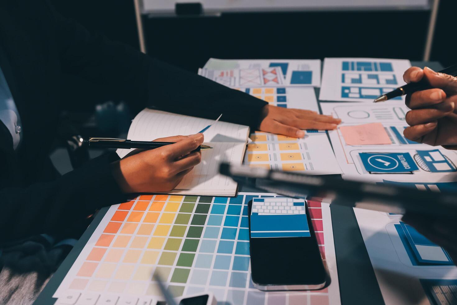 The designer team is designing the uxui system to make the uxui system work well on new phones and support system updates. Website development concept UI UX front end designer photo